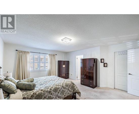 A bedroom with a bed, dresser, and nightstand.