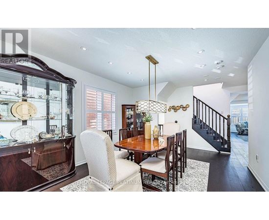 A dining room with a wooden table and chairs.