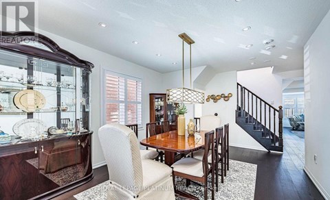 A dining room with a wooden table and chairs.