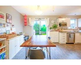 A kitchen with a table and chairs in the middle of the room.