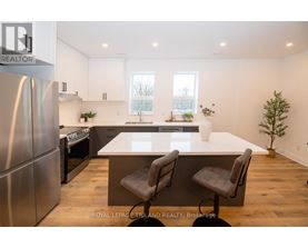 A modern kitchen with a large island and stainless steel appliances.