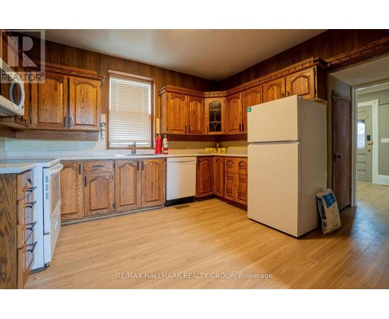 A kitchen with wooden cabinets and a white refrigerator.