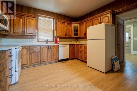 A kitchen with wooden cabinets and a white refrigerator.