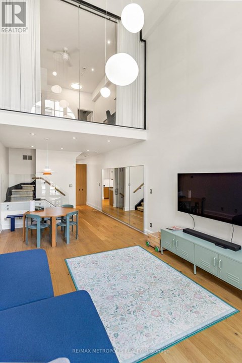 A living room with a blue couch and a television.