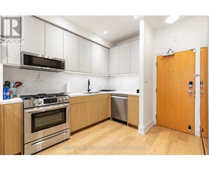 A kitchen with a stove top oven and microwave above it.