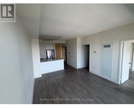 A spacious room with wooden flooring and white walls, ready for a new tenant.