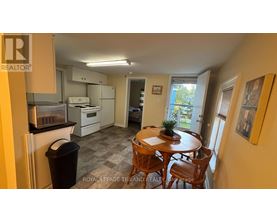 A kitchen with a table and chairs in the middle of the room.