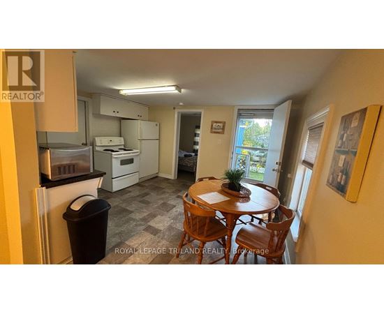 A kitchen with a table and chairs in the middle of the room.