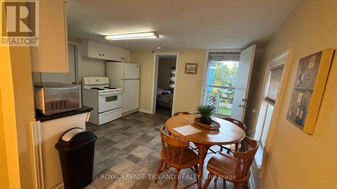 A kitchen with a table and chairs in the middle of the room.