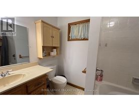 A bathroom with a sink, toilet, and bathtub.