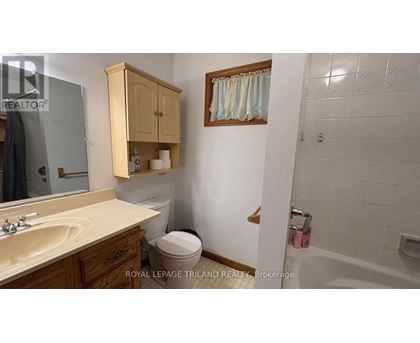 A bathroom with a sink, toilet, and bathtub.