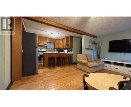 A kitchen with a refrigerator, microwave, and oven.