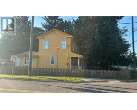 A yellow house with a no parking sign in front of it.