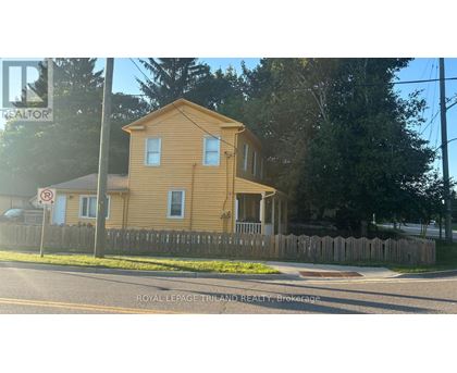 A yellow house with a no parking sign in front of it.