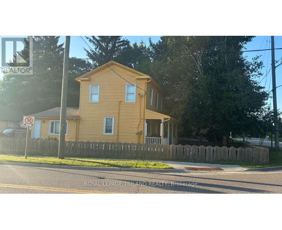 A yellow house with a no parking sign in front of it.