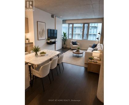 A modern living room with a dining table and chairs.