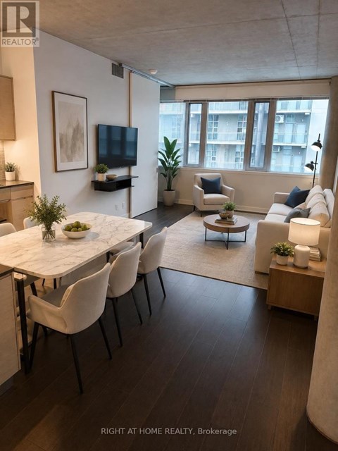 A modern living room with a dining table and chairs.