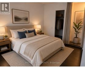 A well-lit bedroom with a large bed and a painting on the wall.