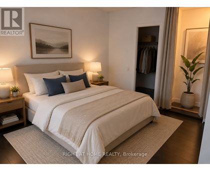 A well-lit bedroom with a large bed and a painting on the wall.