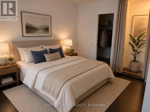 A well-lit bedroom with a large bed and a painting on the wall.