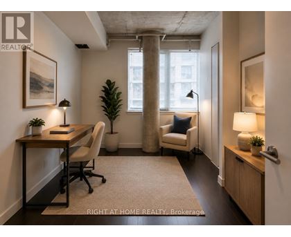 A well-lit office space with a desk, chair, and potted plant.