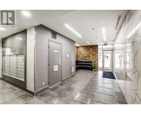 A hallway with a marble floor and a wall with a floral pattern.