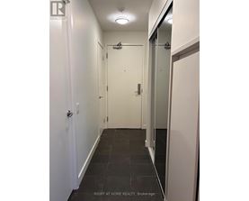 A hallway with a door on the left and a glass door on the right.