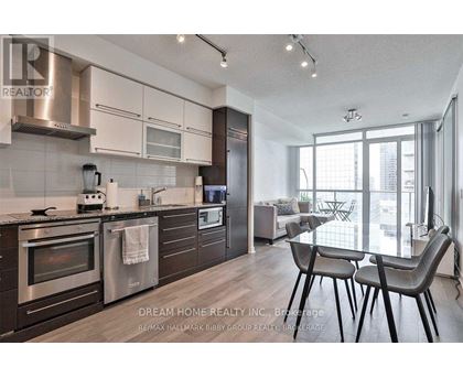 A modern kitchen with a dining table and chairs.