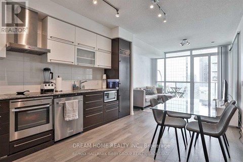 A modern kitchen with a dining table and chairs.