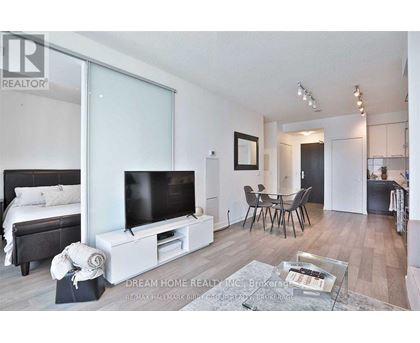 A modern bedroom with a large bed and a flat screen TV.