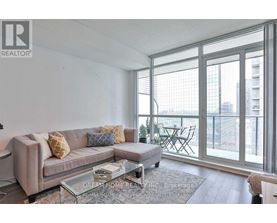 A living room with a couch, coffee table, and sliding glass doors.