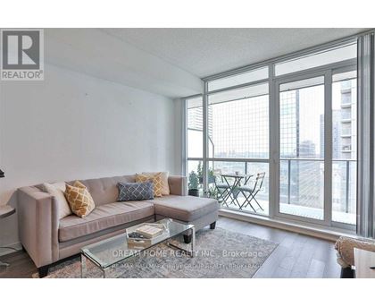 A living room with a couch, coffee table, and sliding glass doors.