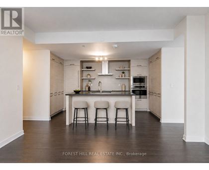 A modern kitchen with a sink and stove top oven.