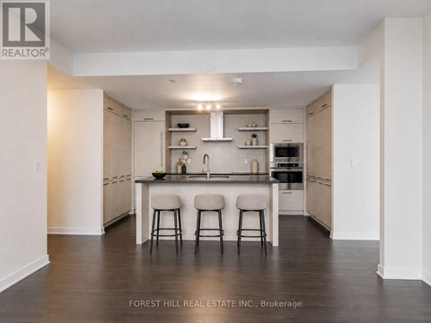 A modern kitchen with a sink and stove top oven.