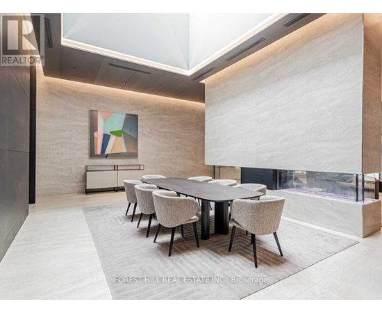 A dining room with a large table and chairs.