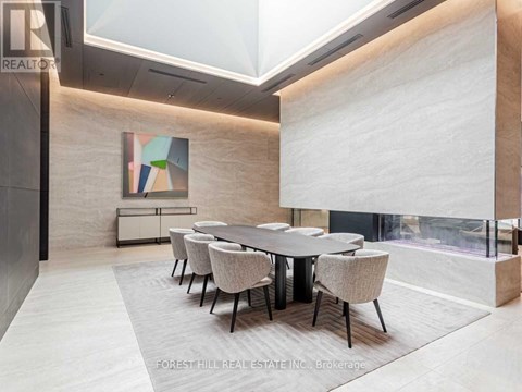 A dining room with a large table and chairs.