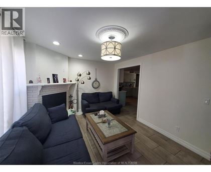 A living room with a dark blue couch and a wooden coffee table.