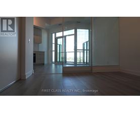 A room with a glass door leading to a balcony.