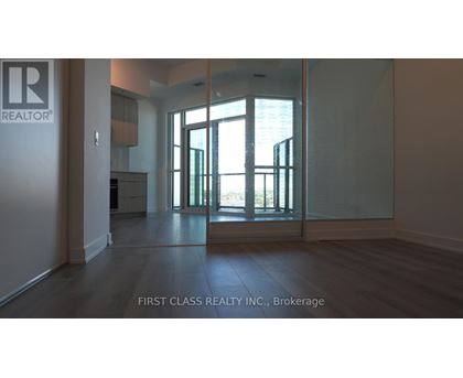 A room with a glass door leading to a balcony.