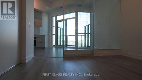 A room with a glass door leading to a balcony.