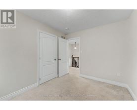 A white door is in a room with a carpet floor.