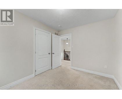 A white door is in a room with a carpet floor.