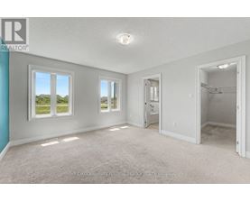 A spacious room with a view of the outdoors through the windows.