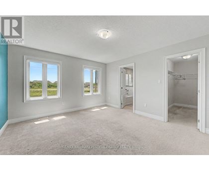 A spacious room with a view of the outdoors through the windows.