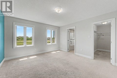 A spacious room with a view of the outdoors through the windows.