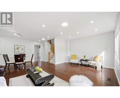 A living room with a white sofa set and a coffee table.