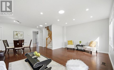 A living room with a white sofa set and a coffee table.