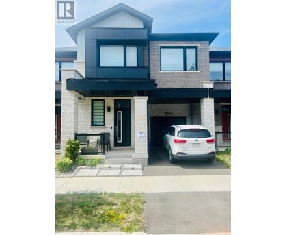 A modern house with a car parked in front.