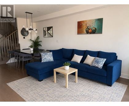 A living room with a blue couch and a wooden coffee table.