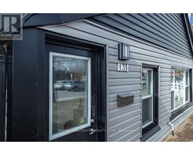 A grey building with a Realtor sign on the front.